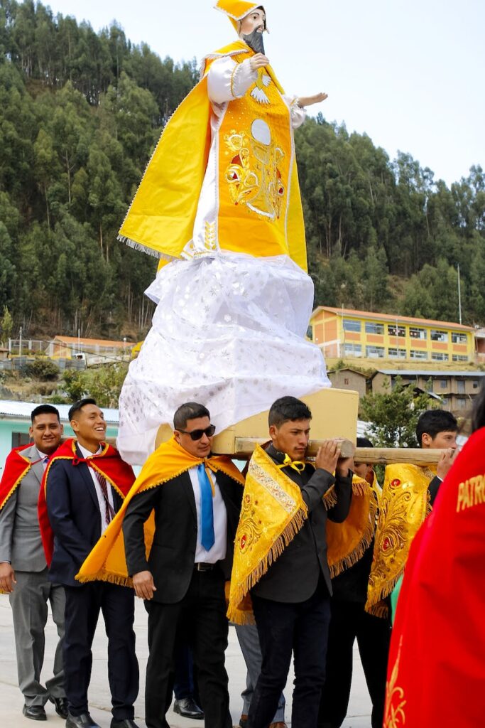 men carrying a statue during a procession